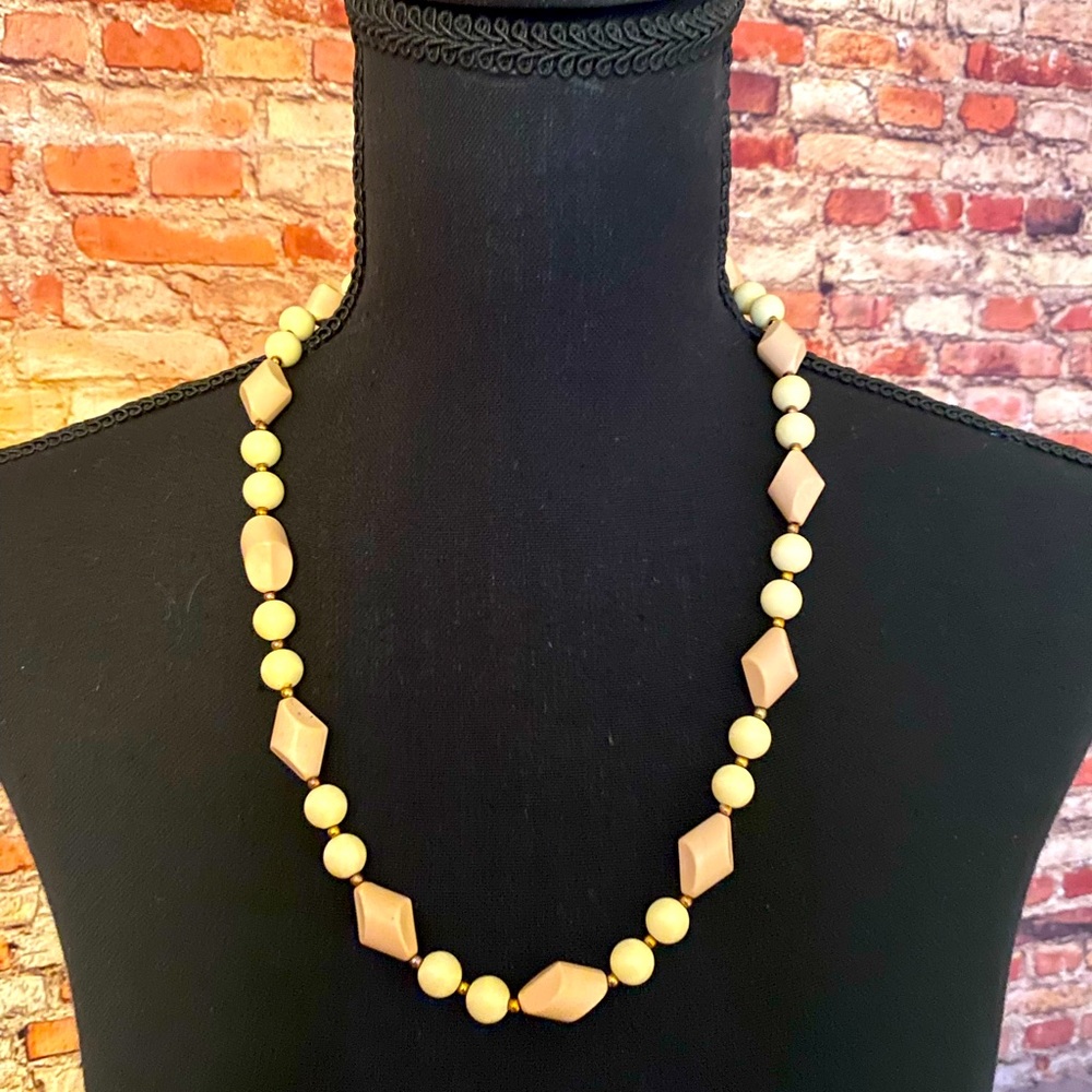 Pink diamond bead and circular cream bead patterned necklace.